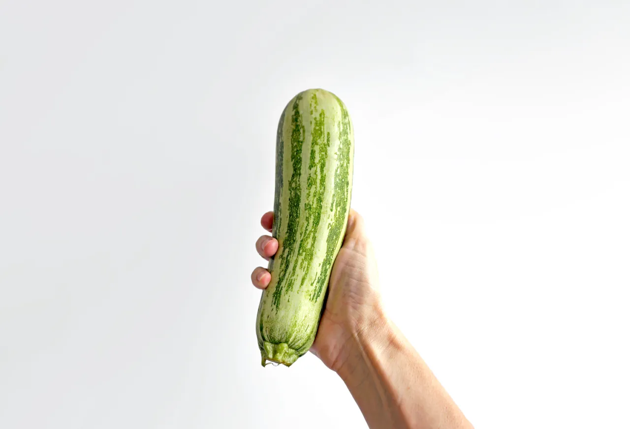 Hand holds zucchini